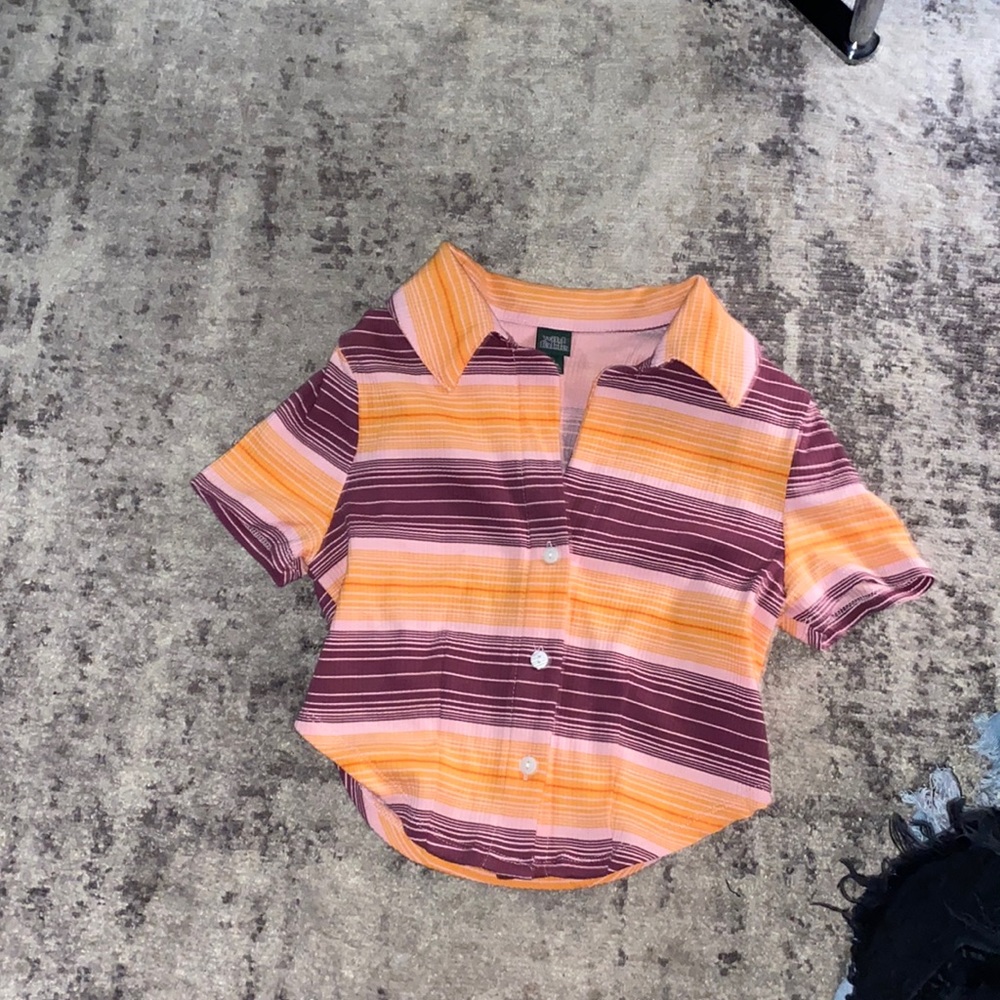 I’m selling a orange and purple, pink shirt.